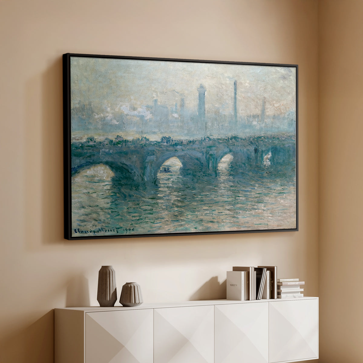 Black floater framed canvas of Waterloo Bridge, Gray Weather, 1900 by Claude Monet, featuring an impressionist cityscape with bridge fading into fog over water above a console cabinet in a minimalist entryway.