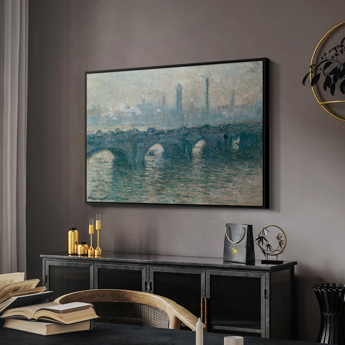 Waterloo Bridge, Gray Weather, 1900 by Claude Monet in a black floater framed canvas featuring a soft-toned river scene with bridge and muted skyline, displayed above a desk in a dark home office interior.