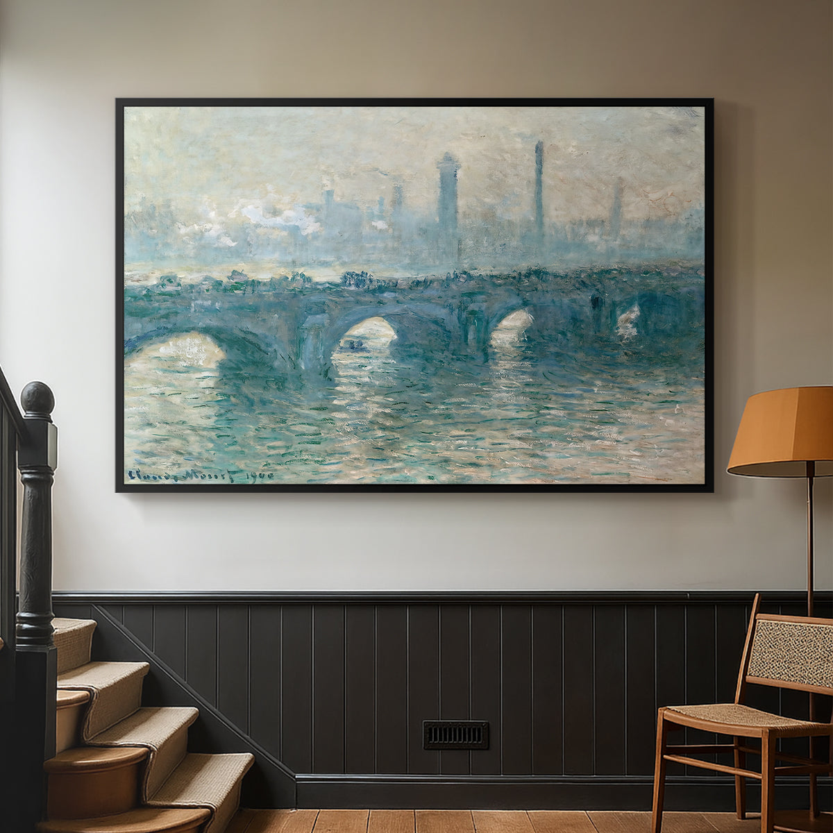 Black floater framed canvas featuring an atmospheric urban landscape with misty light and reflections, displayed in a hallway near a staircase.