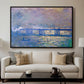 Charing Cross Bridge, 1903 by Claude Monet displayed in a black floater framed canvas above a sofa in a clean living room.