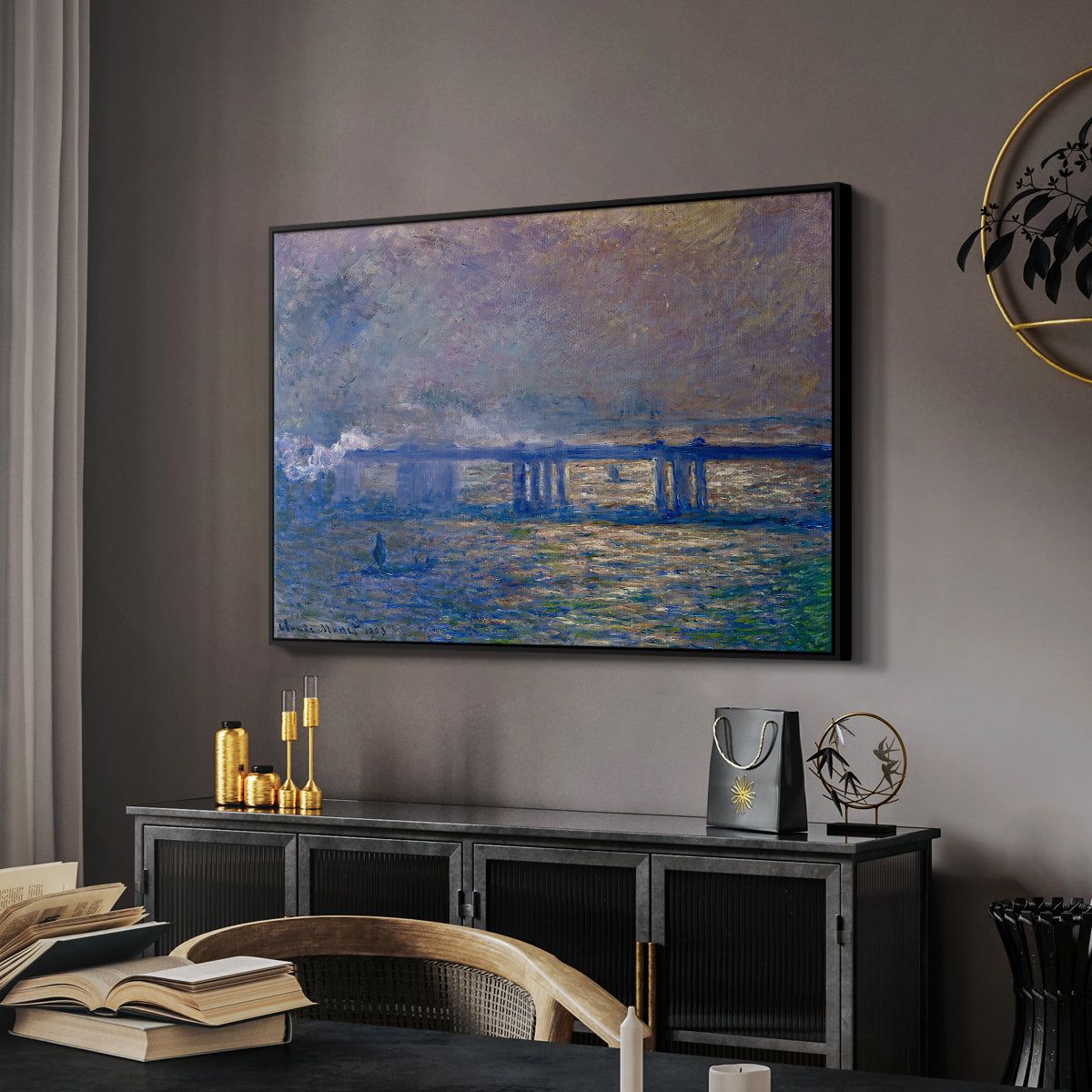 Charing Cross Bridge, 1903 by Claude Monet in a black floater framed canvas featuring an atmospheric depiction of London bridge with reflections in water, displayed above a desk in a dark home office interior.