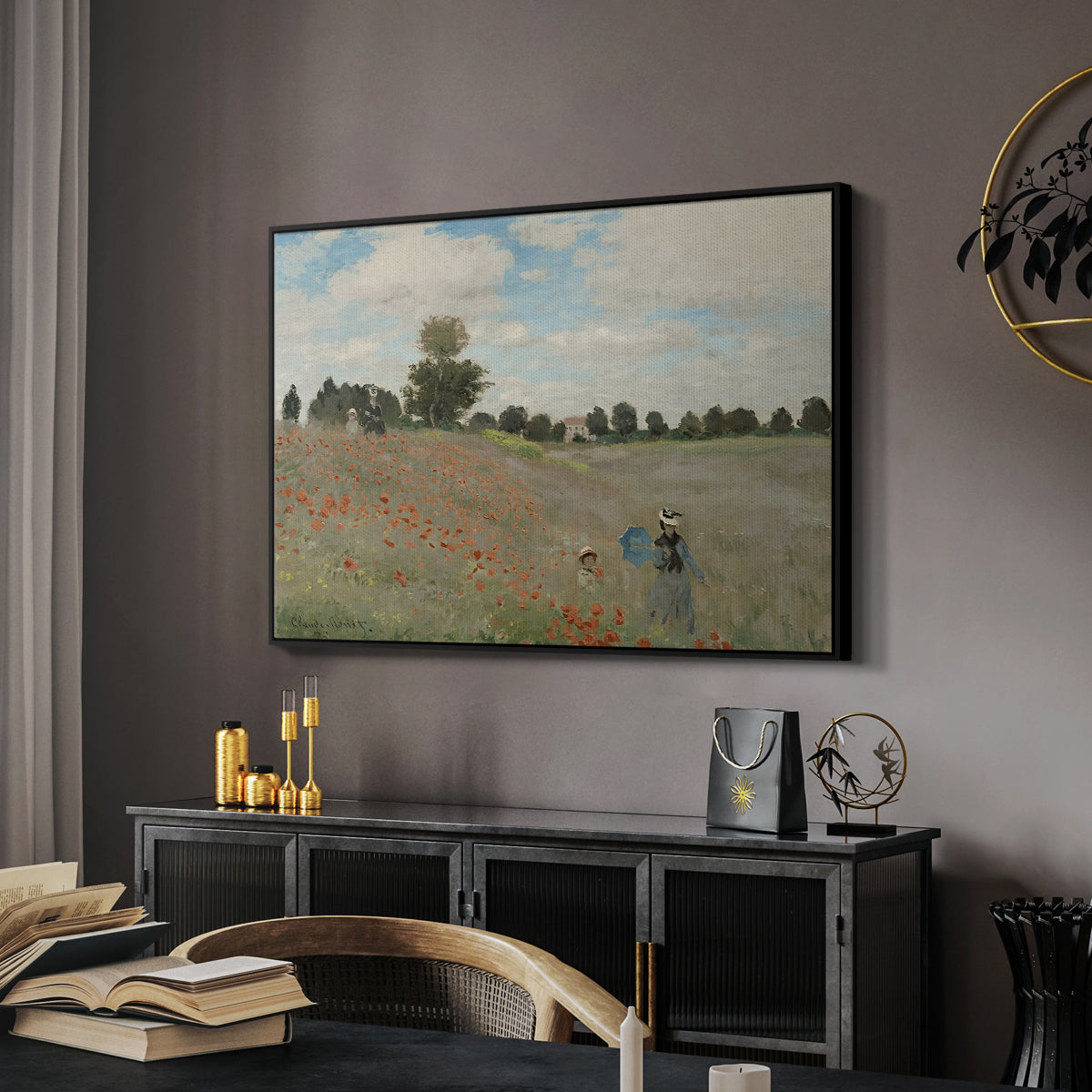 The Poppy Field near Argenteuil, 1873 by Claude Monet in a black floater framed canvas featuring a bright meadow filled with poppies under open sky, displayed above a desk in a dark home office interior.