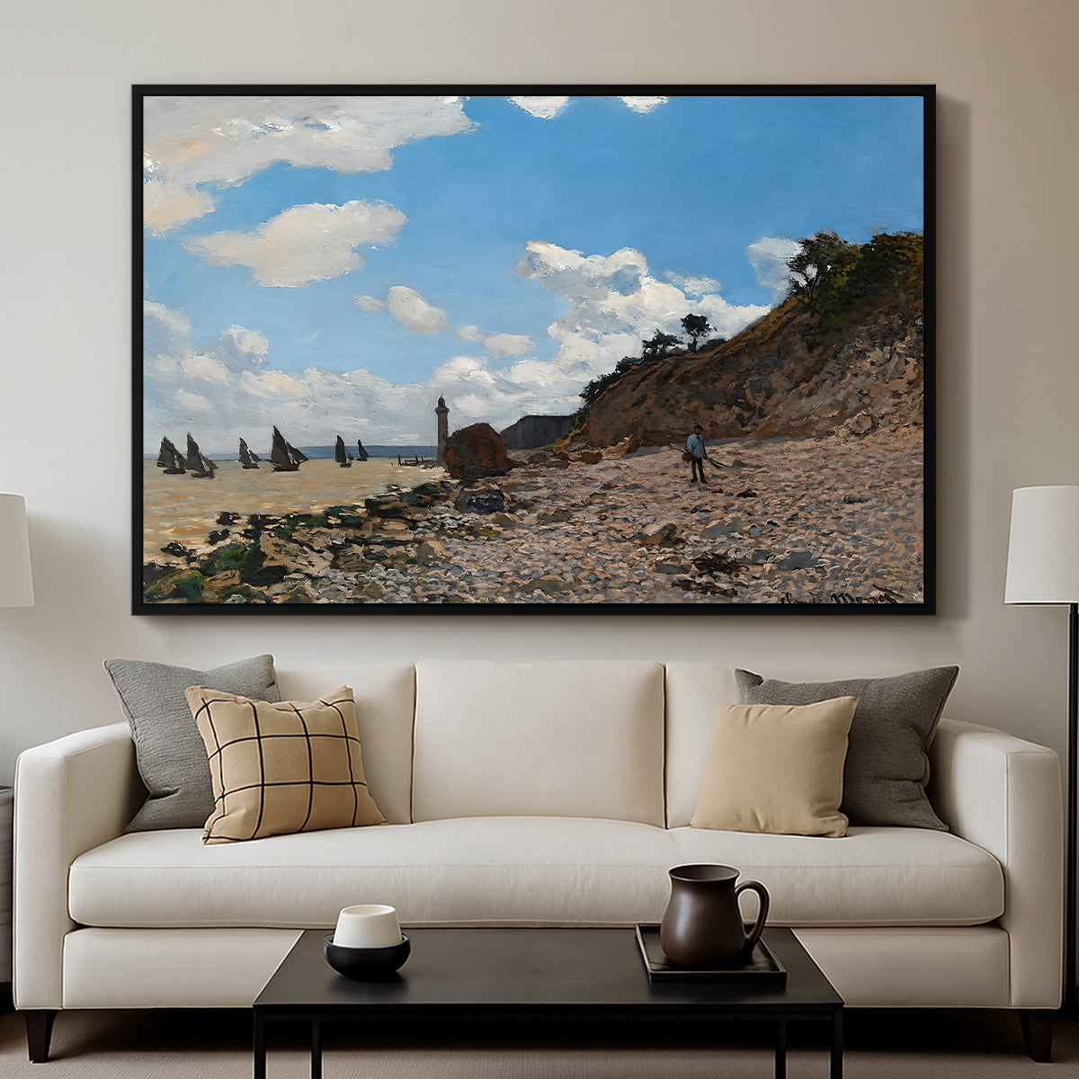 The Beach at Honfleur, 1864 by Claude Monet displayed in a black floater framed canvas above a sofa in a clean living room.