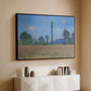 Black floater framed canvas of Poppy Field (Giverny), 1890-1891 by Claude Monet, featuring an impressionist landscape of blooming poppies in countryside above a console cabinet in a minimalist entryway.