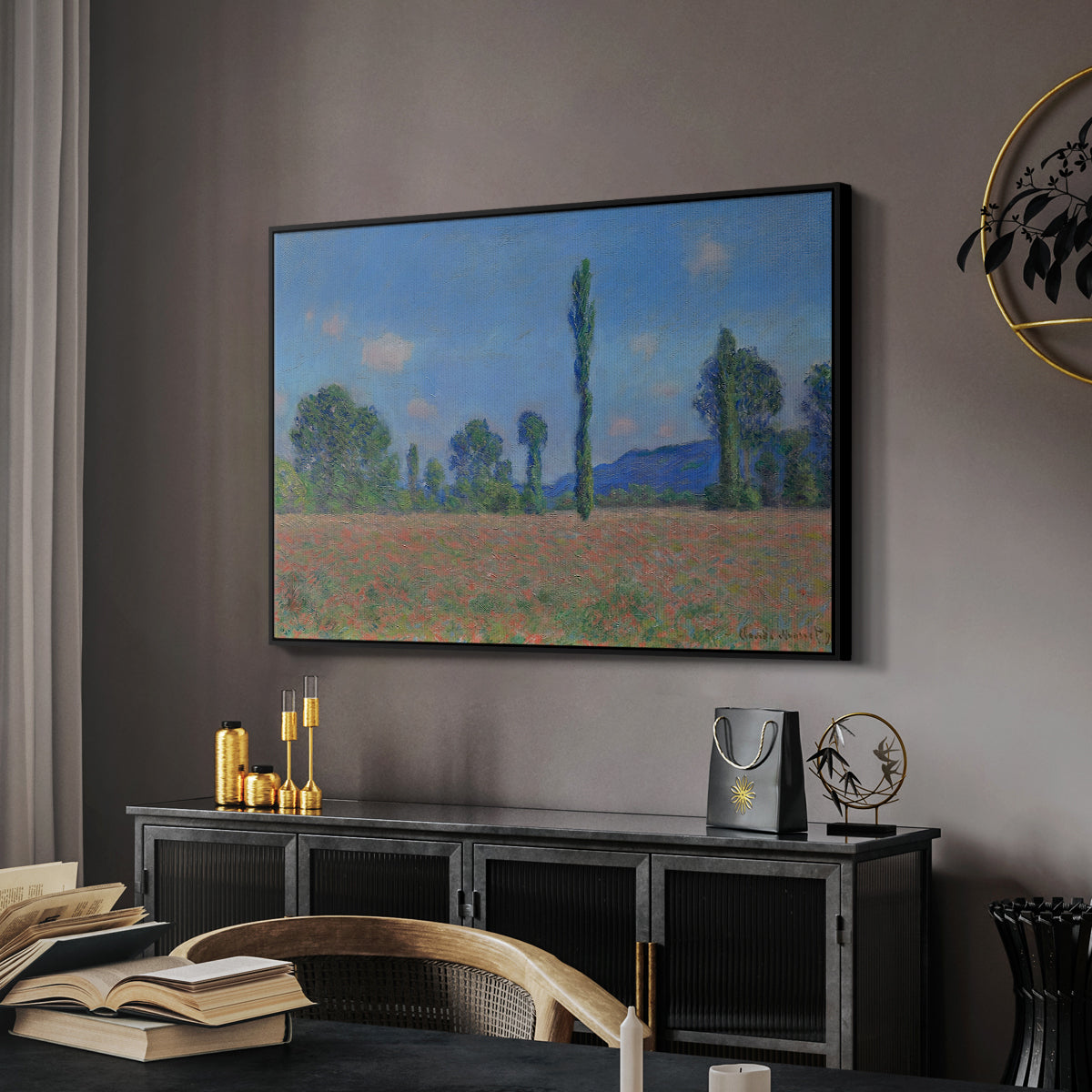 Poppy Field (Giverny), 1890-1891 by Claude Monet in a black floater framed canvas featuring a vibrant meadow scene with flowers and vertical tree forms, displayed above a desk in a dark home office interior.