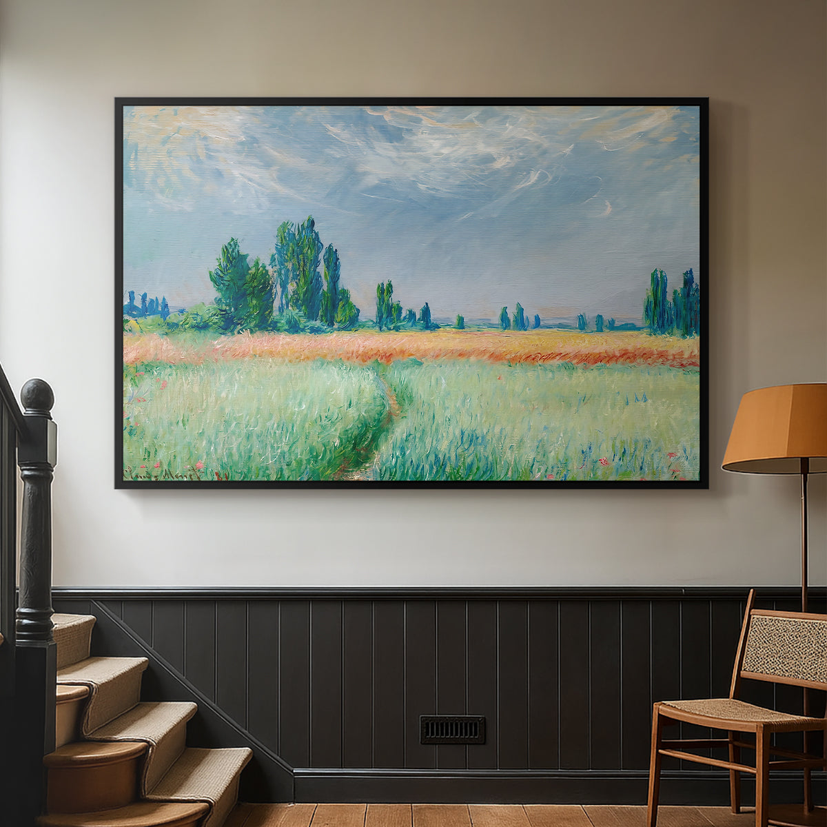 Black floater framed canvas featuring a serene rural scene with textured wheat under natural light, displayed in a hallway near a staircase.