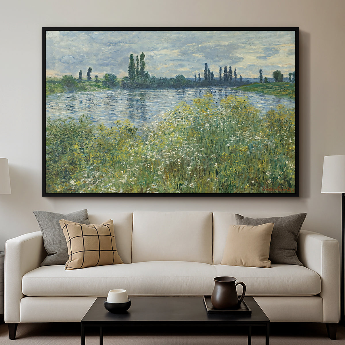 Banks of the Seine, Vétheuil, 1880 by Claude Monet displayed in a black floater framed canvas above a sofa in a clean living room.
