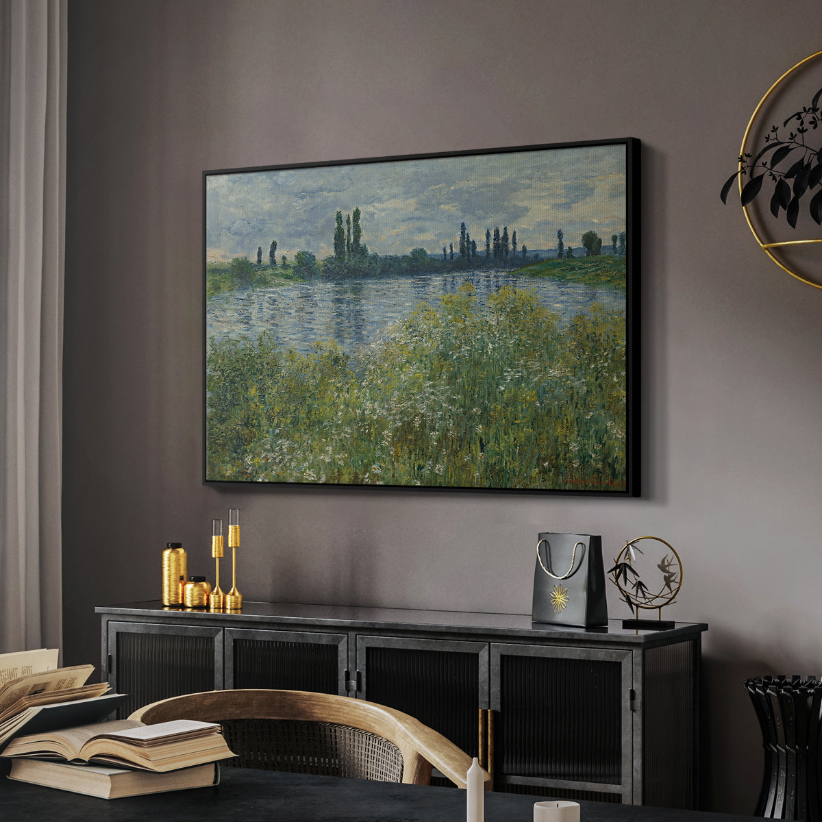 Banks of the Seine, Vétheuil, 1880 by Claude Monet in a black floater framed canvas featuring a tranquil riverside scene with houses and vegetation, displayed above a desk in a dark home office interior.