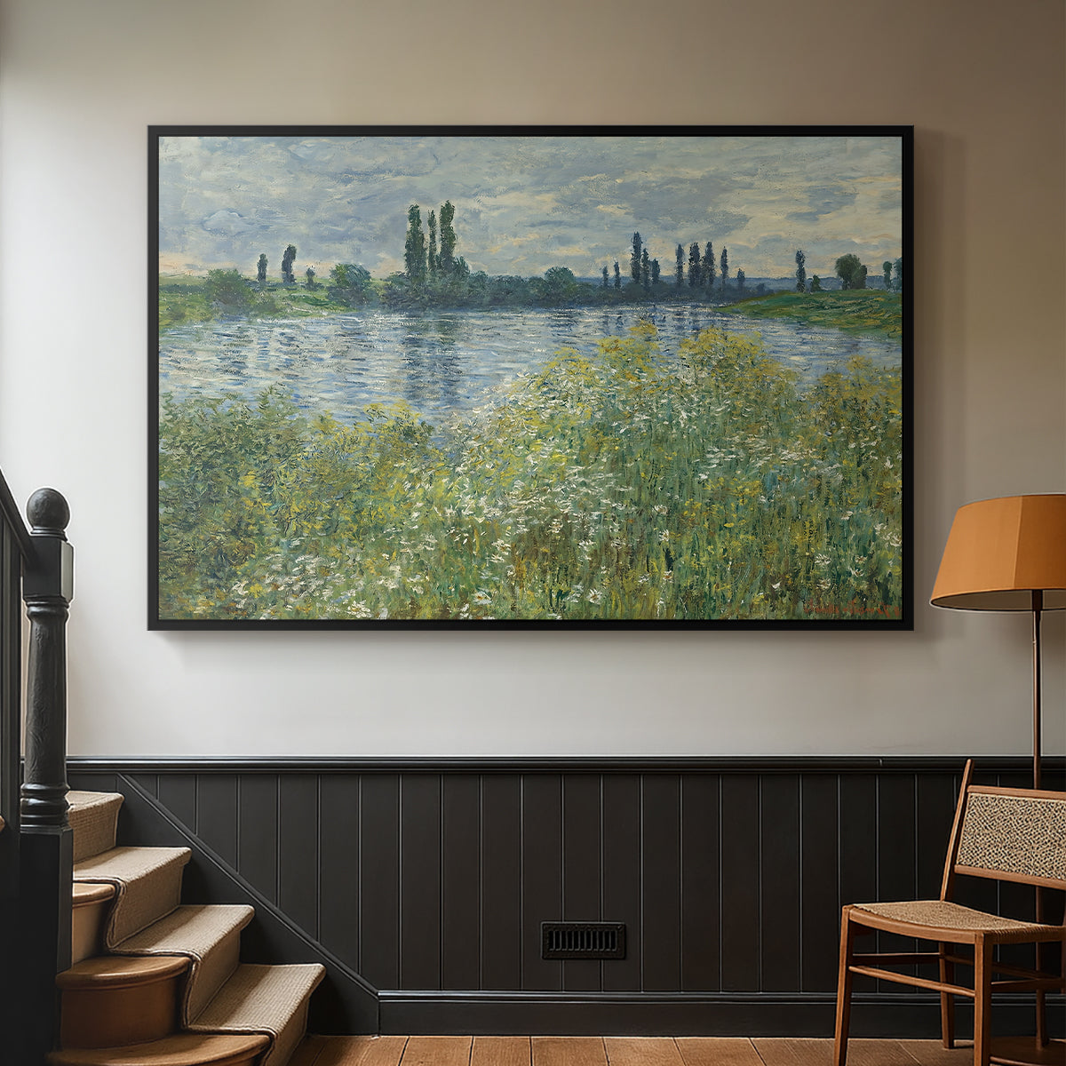 Black floater framed canvas featuring a natural landscape with calm water and soft foliage, displayed in a hallway near a staircase.