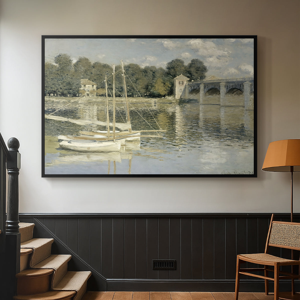 Black floater framed canvas featuring a riverside view with architecture and nautical activity, displayed in a hallway near a staircase.