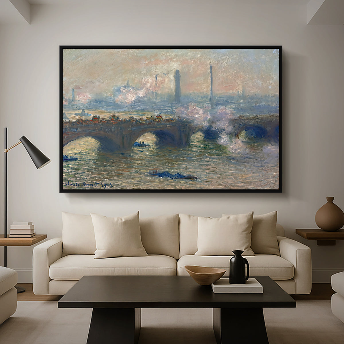 Waterloo Bridge, Gray Day, 1903 by Claude Monet as a black floater framed canvas featuring a muted cityscape of bridge spanning river under overcast sky, displayed above a sofa in a modern living room.