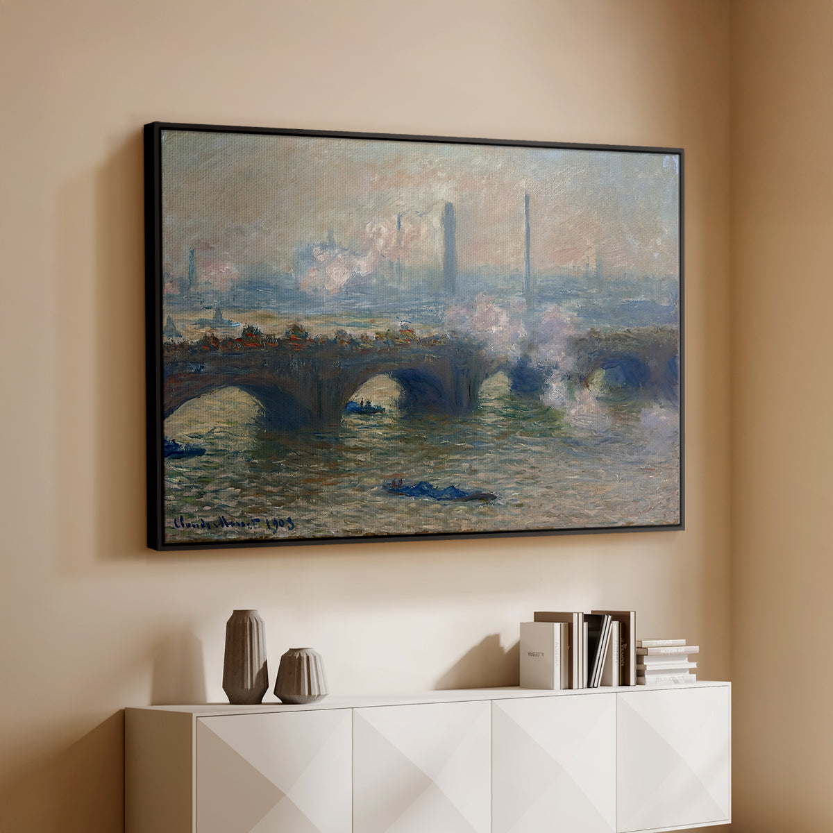 Black floater framed canvas of Waterloo Bridge, Gray Day, 1903 by Claude Monet, featuring an impressionist depiction of bridge with soft gray tones and haze above a console cabinet in a minimalist entryway.