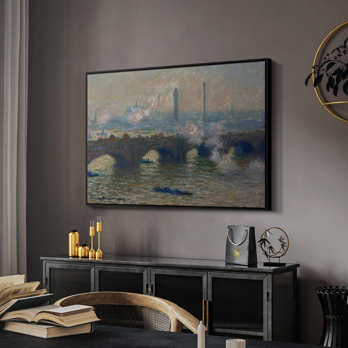 Waterloo Bridge, Gray Day, 1903 by Claude Monet in a black floater framed canvas featuring a river and bridge scene with diffused light and urban backdrop, displayed above a desk in a dark home office interior.