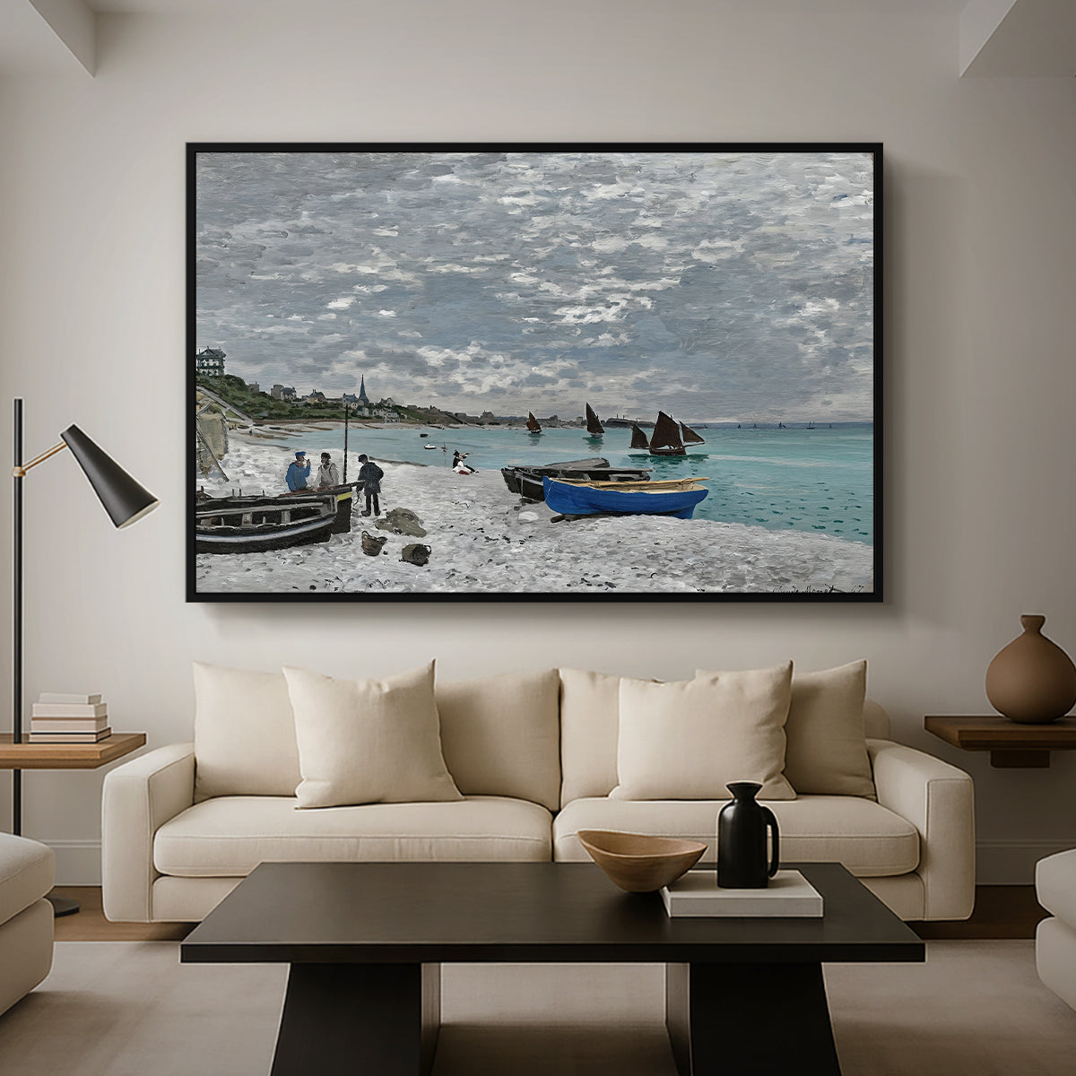 The Beach at Sainte-Adresse, 1867 by Claude Monet as a black floater framed canvas featuring a seaside promenade with figures, flags, and boats along the coast, displayed above a sofa in a modern living room.
