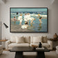 A Holiday, c. 1915 by Edward Henry Potthast as a black floater framed canvas featuring people relaxing and wading in shallow ocean water along a sunny beach, displayed above a sofa in a modern living room.