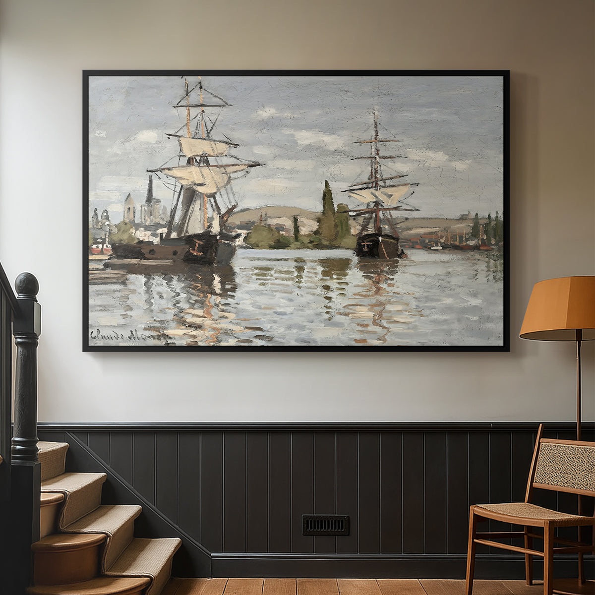 Black floater framed canvas featuring a nautical landscape with vessels resting on calm water, displayed in a hallway near a staircase.
