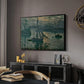 Sunrise (Marine), 1873 by Claude Monet in a black floater framed canvas featuring an early morning harbor scene with boats and diffused light, displayed above a desk in a dark home office interior.