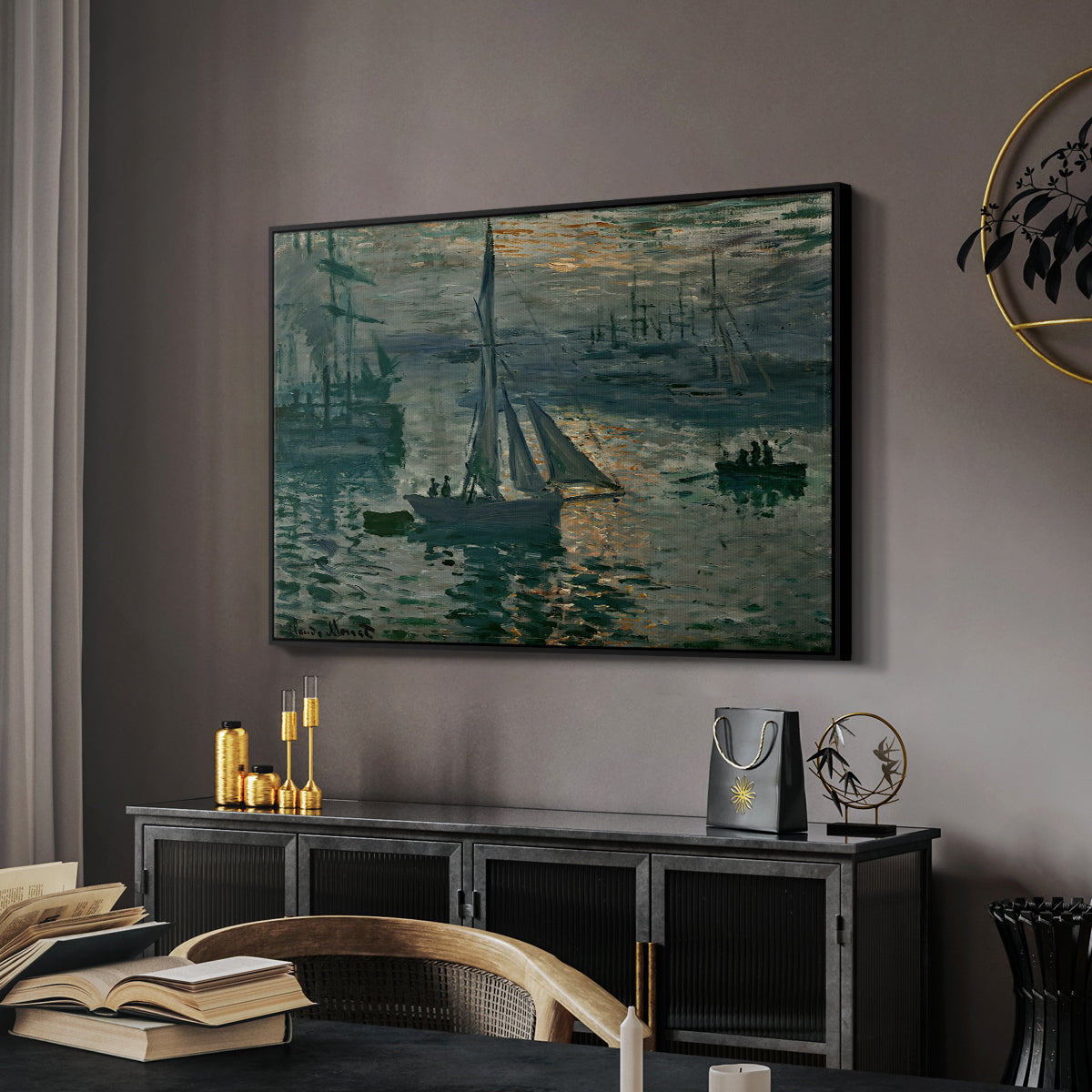 Sunrise (Marine), 1873 by Claude Monet in a black floater framed canvas featuring an early morning harbor scene with boats and diffused light, displayed above a desk in a dark home office interior.