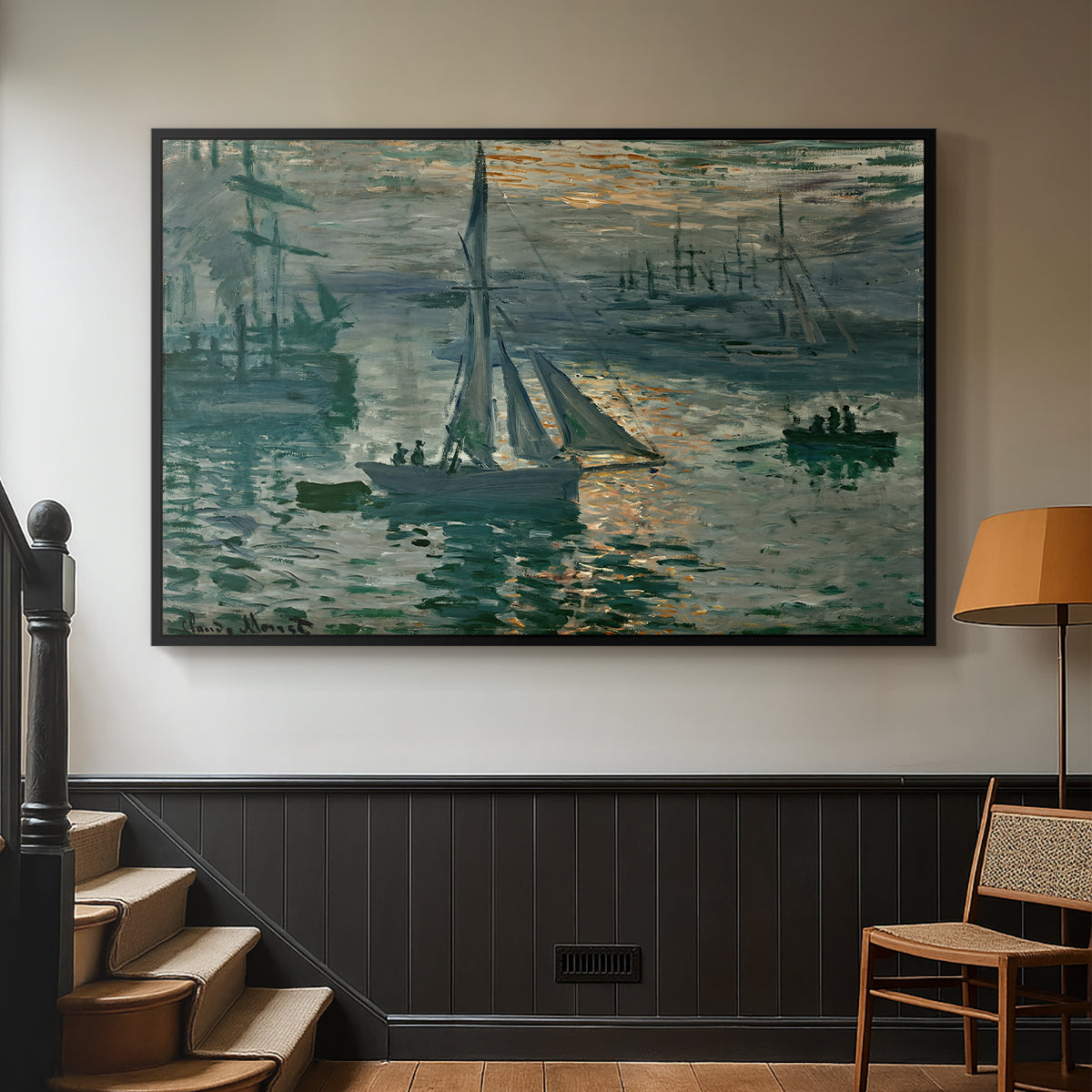 Black floater framed canvas featuring an atmospheric ocean view with sun rising through haze, displayed in a hallway near a staircase.