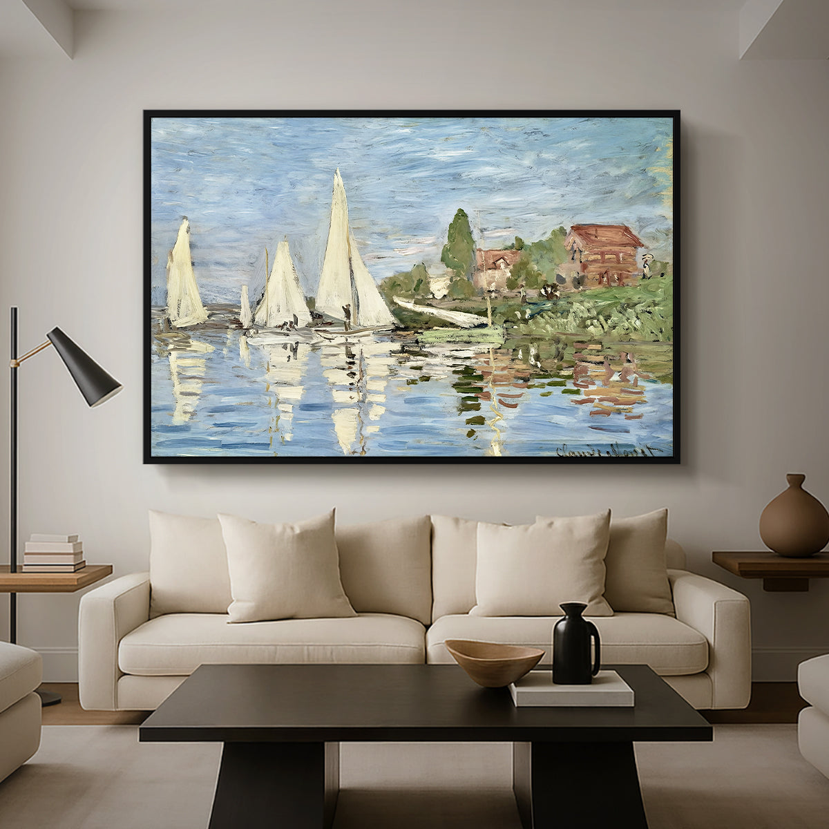 Regatta at Argenteuil, 1872 by Claude Monet as a black floater framed canvas featuring colorful sailboats racing across river under bright sky, displayed above a sofa in a modern living room.