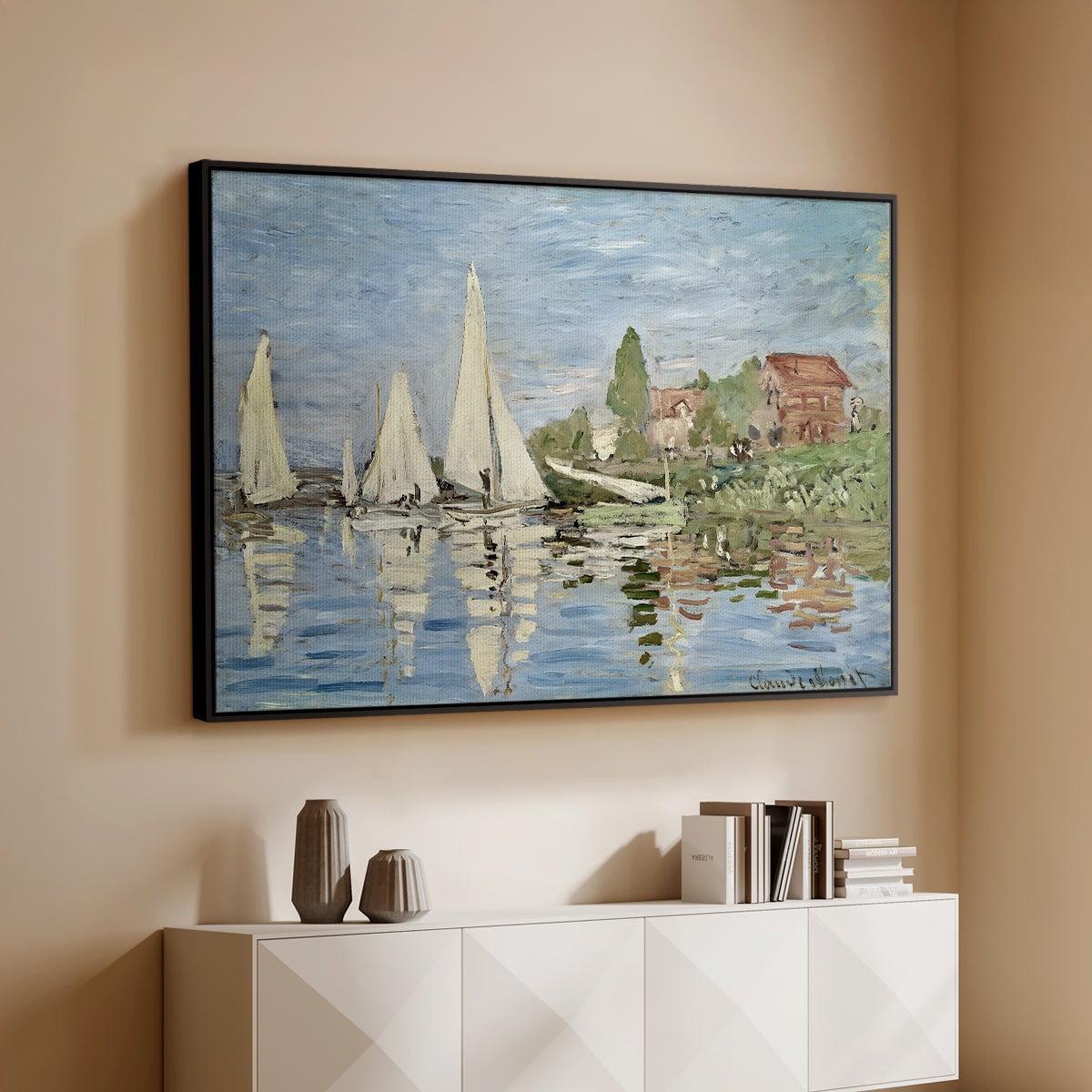 Black floater framed canvas of Regatta at Argenteuil, 1872 by Claude Monet, featuring a lively regatta scene with multiple boats and fluttering sails above a console cabinet in a minimalist entryway.