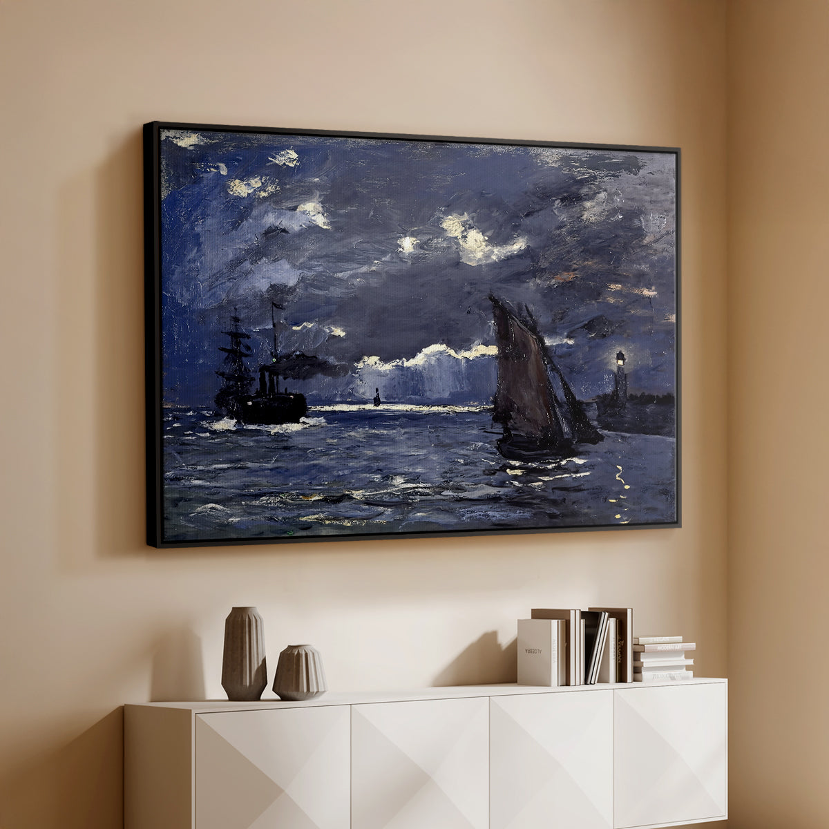 Black floater framed canvas of A Seascape, Shipping by Moonlight, 1864 by Claude Monet, featuring a nocturnal seascape with boats silhouetted against glowing moon above a console cabinet in a minimalist entryway.