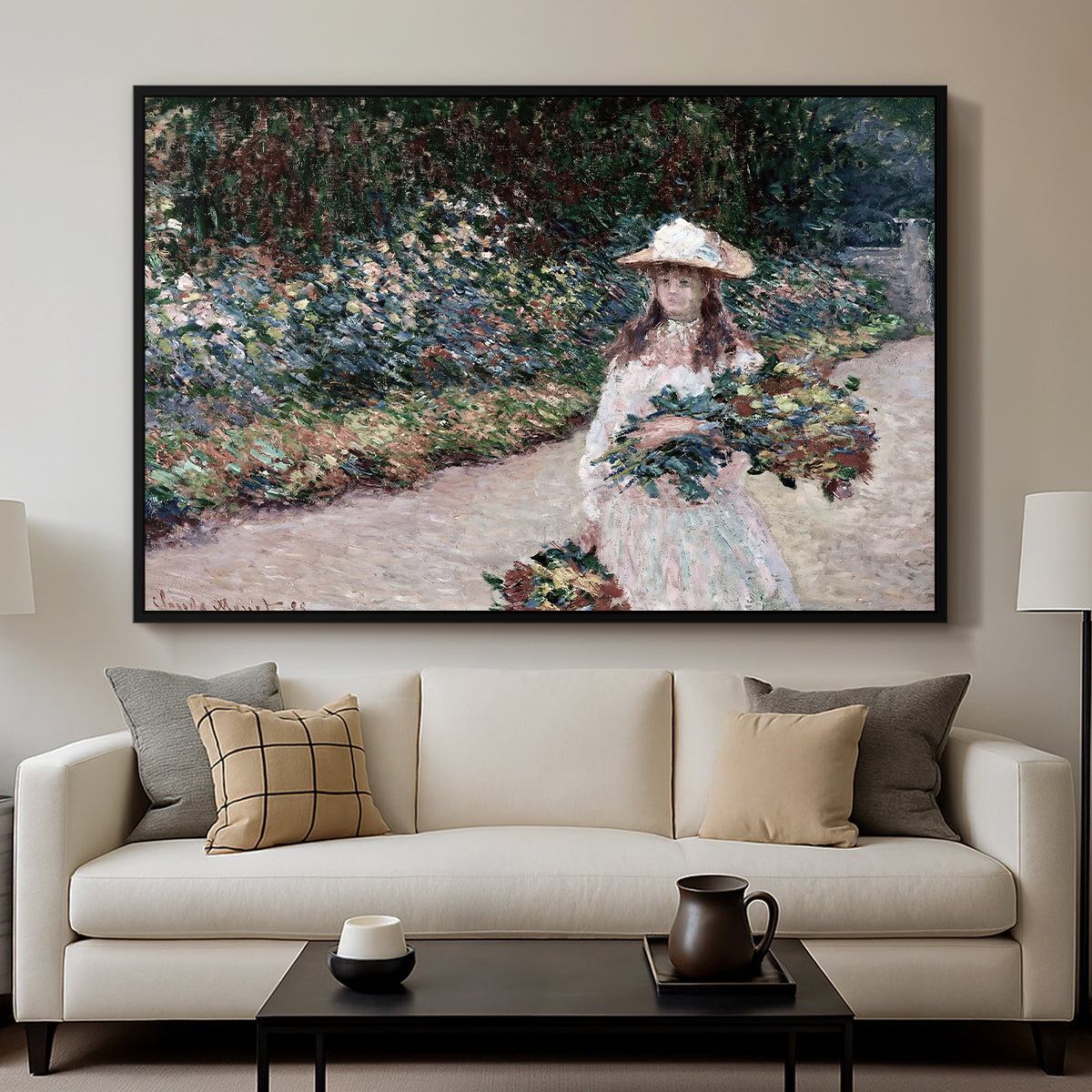 Young Girl in the Garden at Giverny, 1888 by Claude Monet displayed in a black floater framed canvas above a sofa in a clean living room.