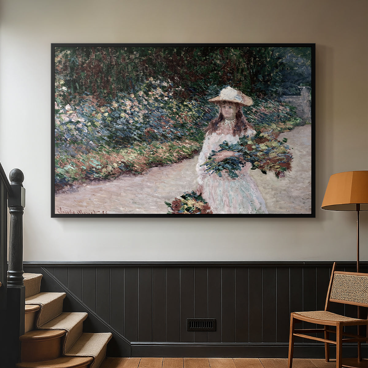Black floater framed canvas featuring a tranquil outdoor portrait of girl in floral setting, displayed in a hallway near a staircase.