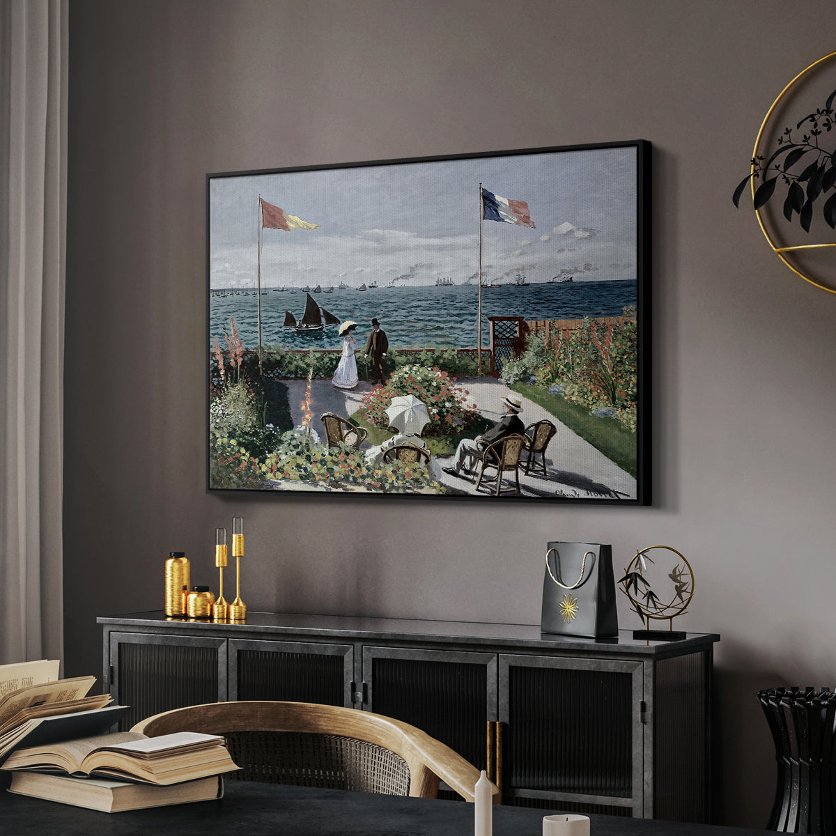 Garden at Sainte-Adresse, 1867 by Claude Monet in a black floater framed canvas featuring a vibrant garden scene with colorful blooms and distant sea, displayed above a desk in a dark home office interior.