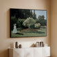 Black floater framed canvas of Woman in the Garden, Sainte-Adresse, 1867 by Claude Monet, featuring an impressionist figure in sunlit garden with lush vegetation above a console cabinet in a minimalist entryway.