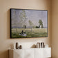 Black floater framed canvas of Summer (L'ete), 1874 by Claude Monet, featuring an impressionist countryside scene with figure resting in shade above a console cabinet in a minimalist entryway.