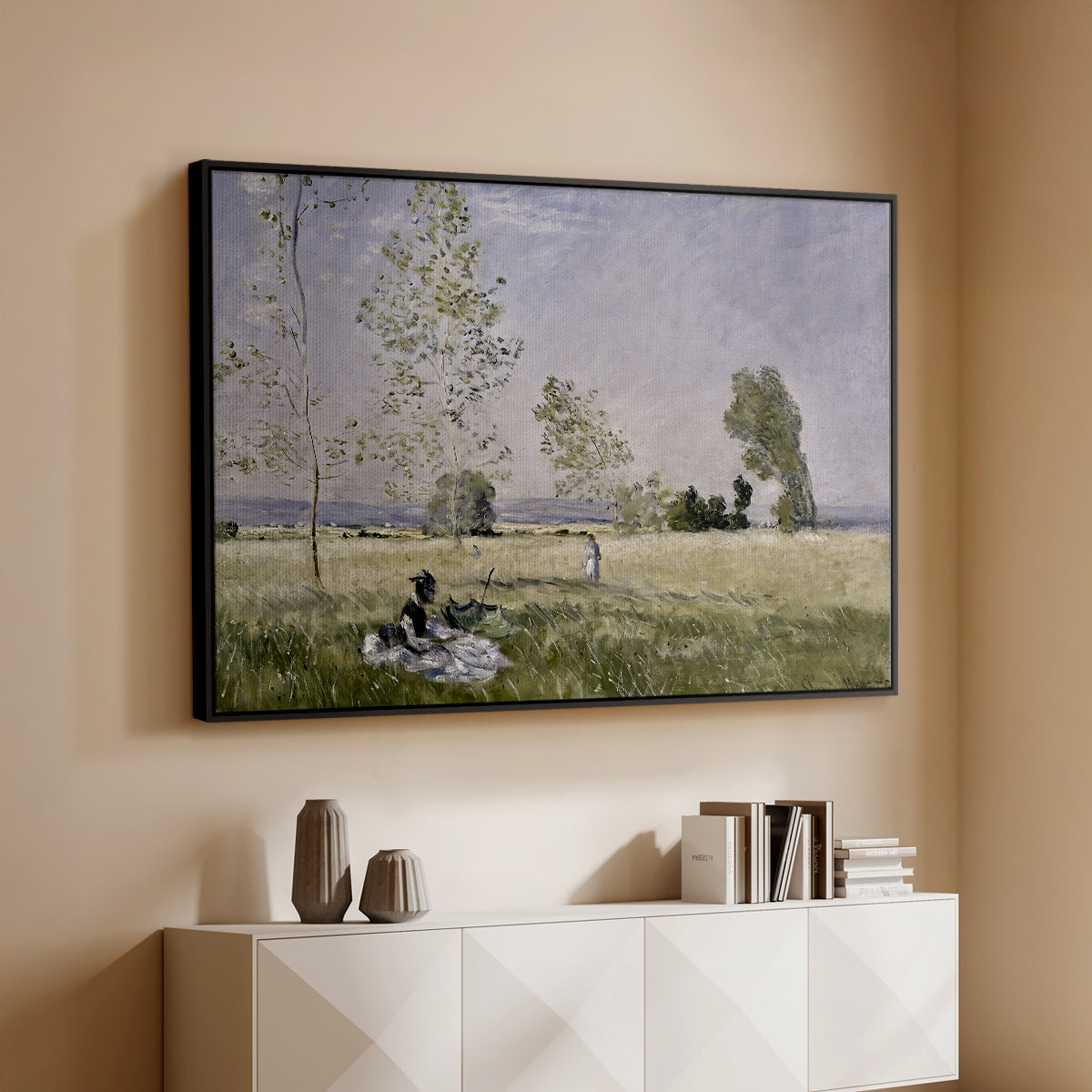 Black floater framed canvas of Summer (L'ete), 1874 by Claude Monet, featuring an impressionist countryside scene with figure resting in shade above a console cabinet in a minimalist entryway.
