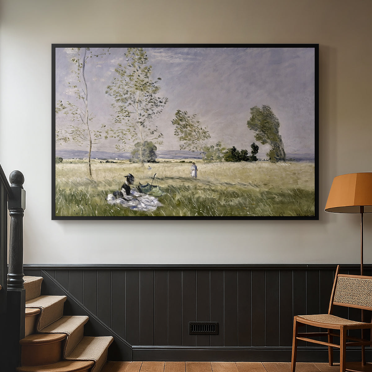 Black floater framed canvas featuring a tranquil summer landscape with lone figure in nature, displayed in a hallway near a staircase.