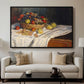 Still Life with Apples and Grapes, 1880 by Claude Monet displayed in a black floater framed canvas above a sofa in a clean living room.