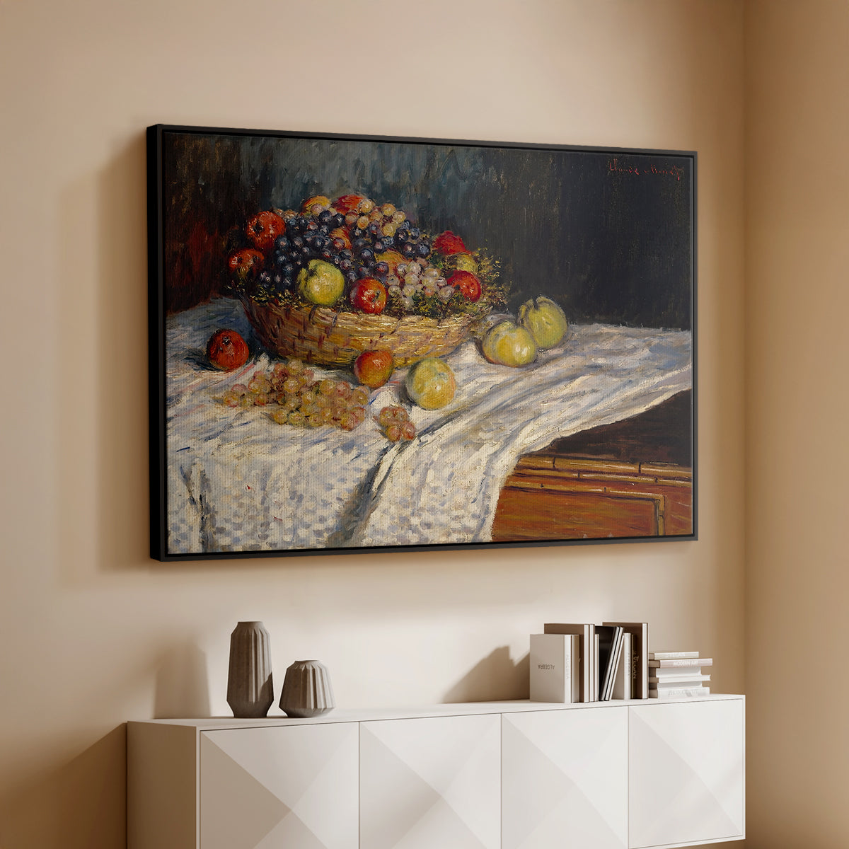 Black floater framed canvas of Still Life with Apples and Grapes, 1880 by Claude Monet, featuring an impressionist still life of fruit placed on cloth-covered surface above a console cabinet in a minimalist entryway.