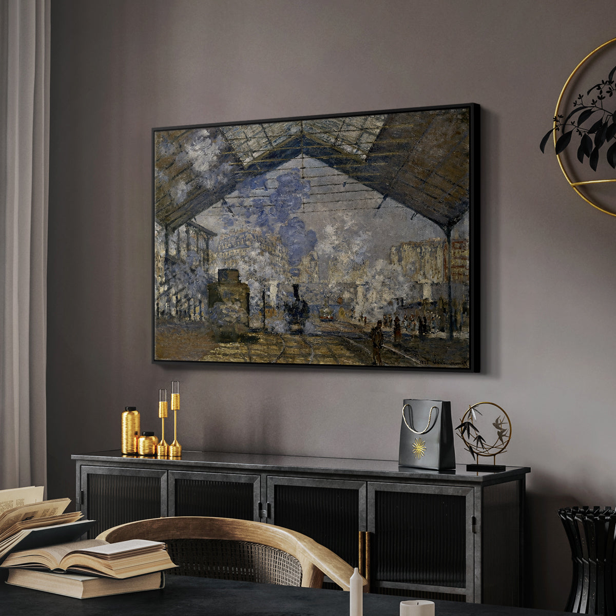 The Gare Saint-Lazare, 1877 by Claude Monet in a black floater framed canvas featuring an industrial interior with steam clouds and rail tracks, displayed above a desk in a dark home office interior.