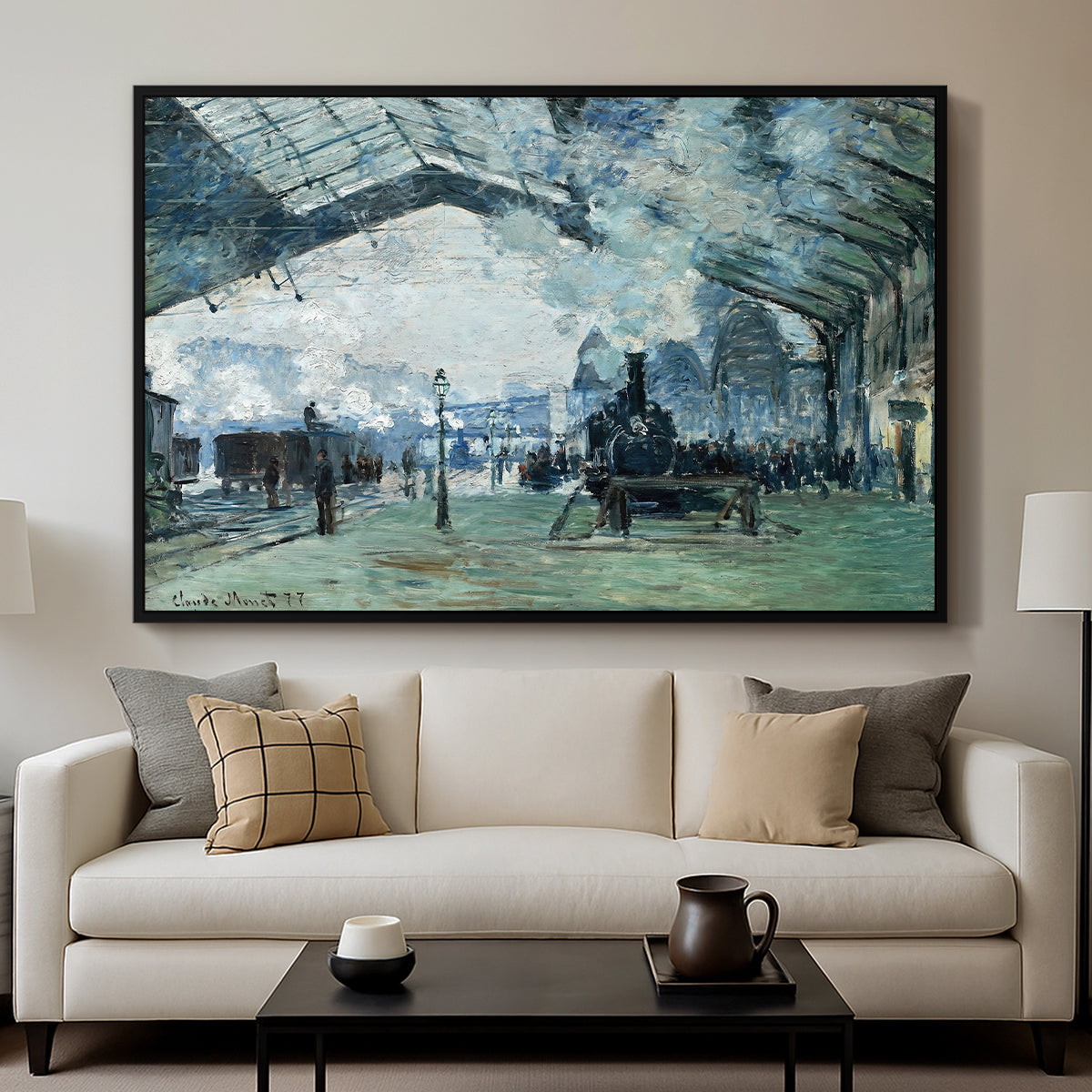 The Saint-Lazare Station, 1877 by Claude Monet displayed in a black floater framed canvas above a sofa in a clean living room.