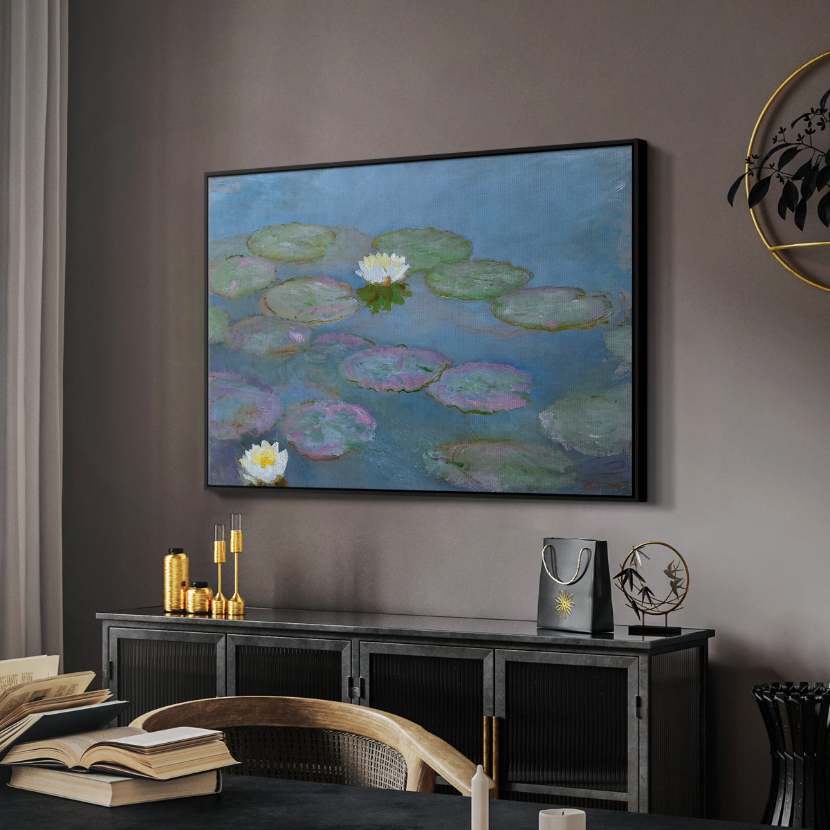 Water Lilies (Nymphéas), 1897-1899 by Claude Monet in a black floater framed canvas featuring a tranquil water surface covered with blooming lilies, displayed above a desk in a dark home office interior.