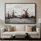 Windmills near Zaandam, 1871 by Claude Monet displayed in a black floater framed canvas above a sofa in a clean living room.