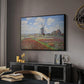 Tulip Fields with the Rijnsburg Windmill, 1886 by Claude Monet in a black floater framed canvas featuring an impressionist field of blooming tulips under bright sky, displayed above a desk in a dark home office interior.