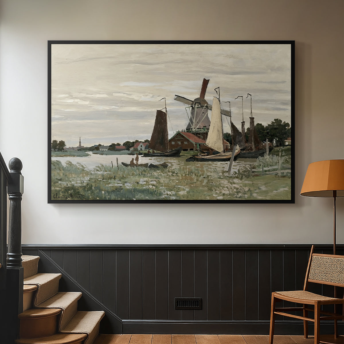 Black floater framed canvas featuring a countryside structure standing against open sky, displayed in a hallway near a staircase.