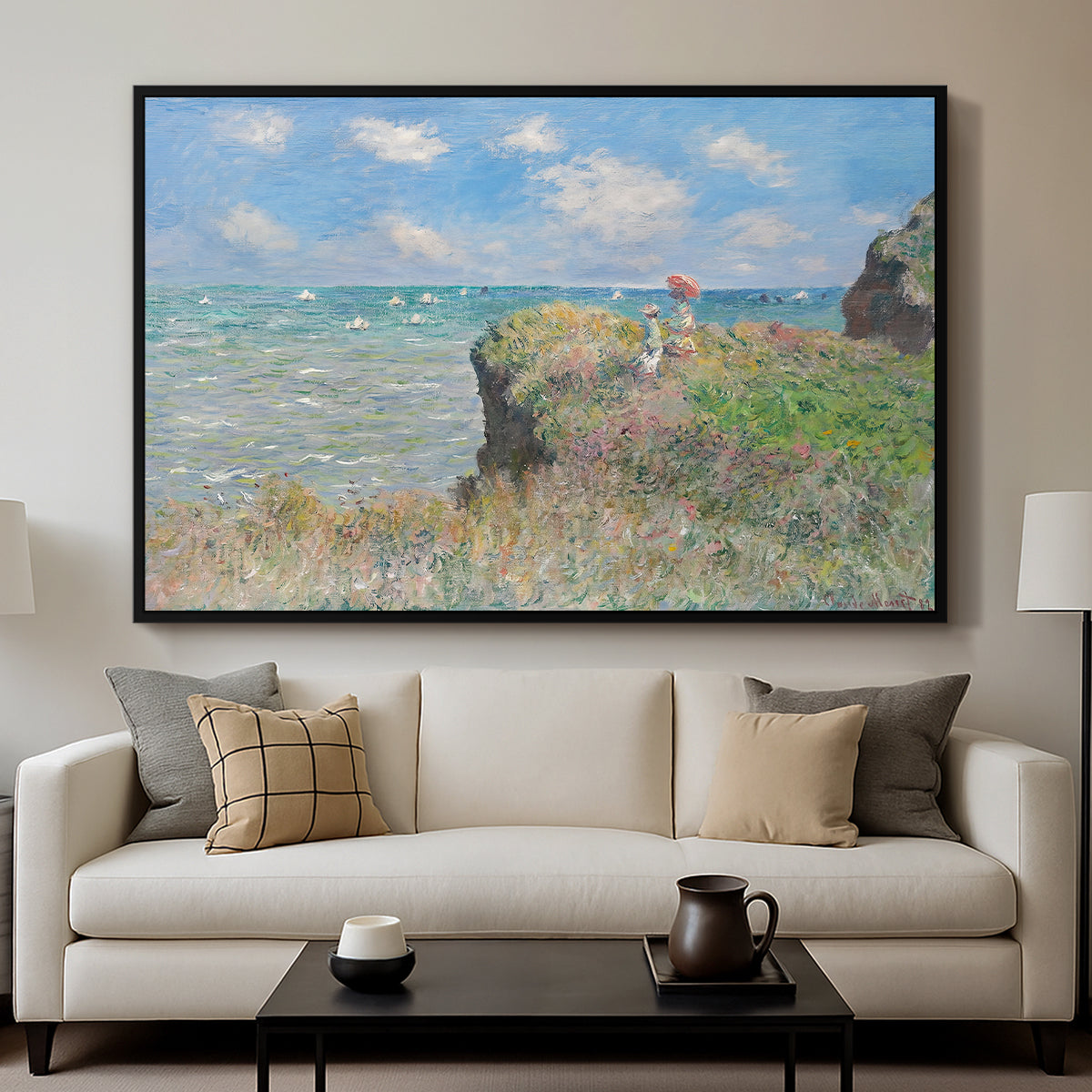 The Cliff Walk at Pourville, 1882 by Claude Monet displayed in a black floater framed canvas above a sofa in a clean living room.