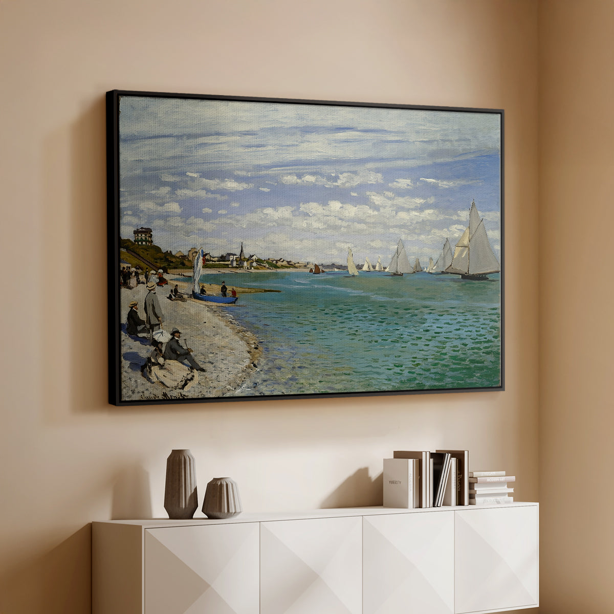 Black floater framed canvas of Regatta at Sainte-Adresse, 1867 by Claude Monet, featuring a lively regatta scene with boats and people on beach above a console cabinet in a minimalist entryway.