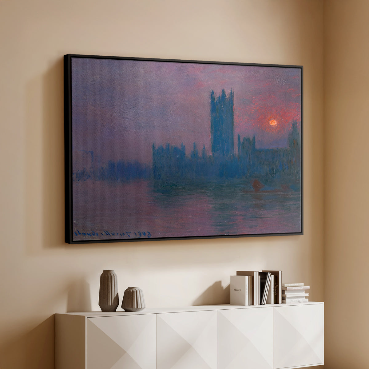 Black floater framed canvas of The Houses of Parliament, Sunset, 1903 by Claude Monet, featuring an impressionist cityscape with warm sunset light over water above a console cabinet in a minimalist entryway.