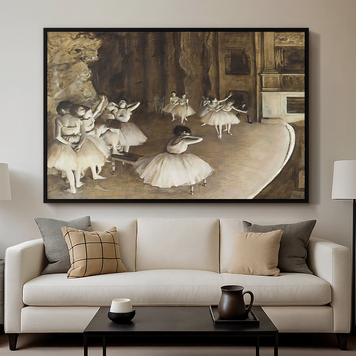 The Rehearsal of the Ballet Onstage, 1874 by Edgar Degas displayed in a black floater framed canvas above a sofa in a clean living room.