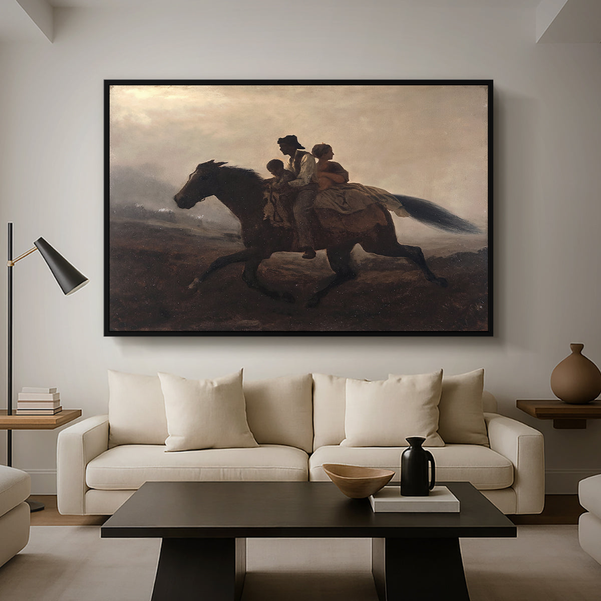 A Ride for Liberty – The Fugitive Slaves, c. 1862 by Eastman Johnson as a black floater framed canvas featuring a family riding horseback through night escaping across landscape, displayed above a sofa in a modern living room.