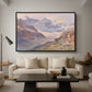 Odenwinklkees with the Johannisberg, 1902 by Edward Theodore Compton as a black floater framed canvas featuring an alpine glacier landscape with rugged peaks and snow-covered terrain, displayed above a sofa in a modern living room.