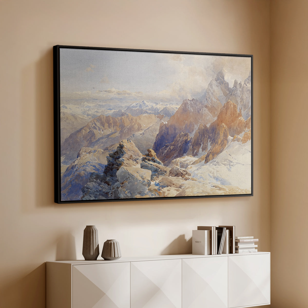 Black floater framed canvas of Col du Géant, 1903 by Edward Theodore Compton, featuring a high mountain landscape featuring dramatic ridges and glacier terrain above a console cabinet in a minimalist entryway.
