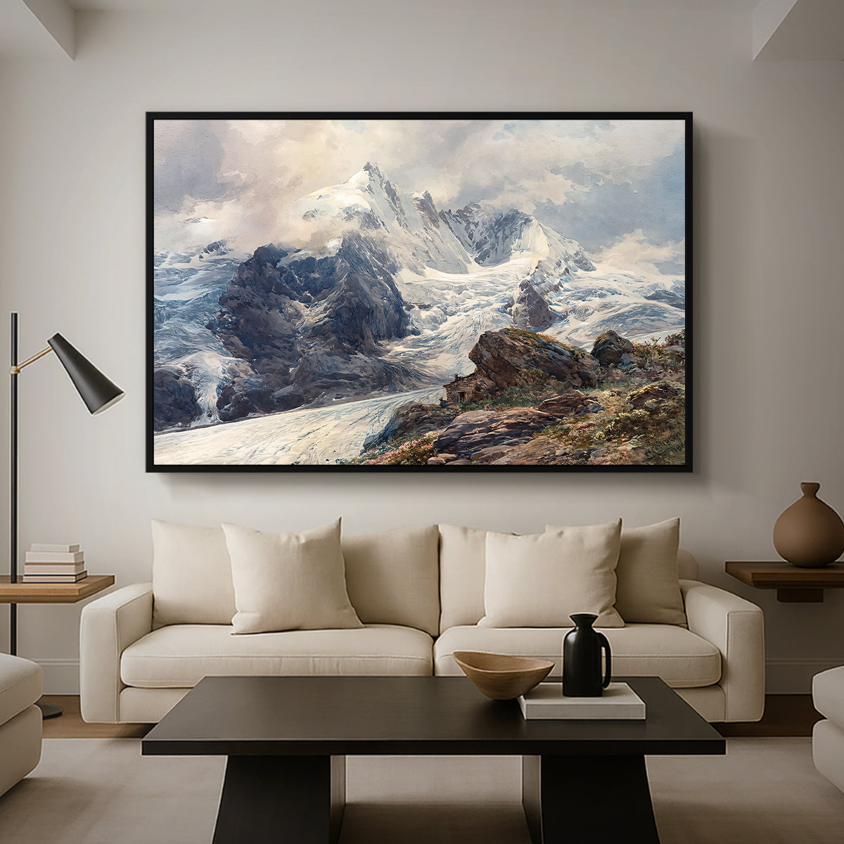The Grossglockner, 1880 by Edward Theodore Compton as a black floater framed canvas featuring a towering mountain peak rising above rocky alpine landscape, displayed above a sofa in a modern living room.
