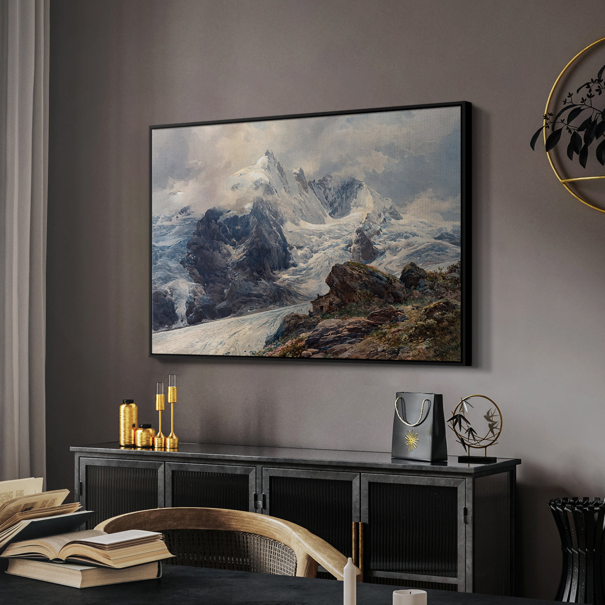 The Grossglockner, 1880 by Edward Theodore Compton in a black floater framed canvas featuring a realistic landscape of high mountain under open sky, displayed above a desk in a dark home office interior.